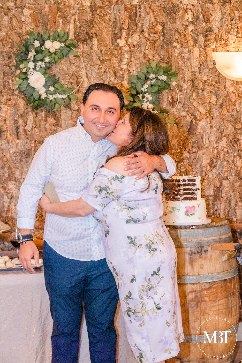 mom of the bride to be hugging & kissing groom to be taken in Waterford, Virginia at a bridal shower covered by a DC event photographer