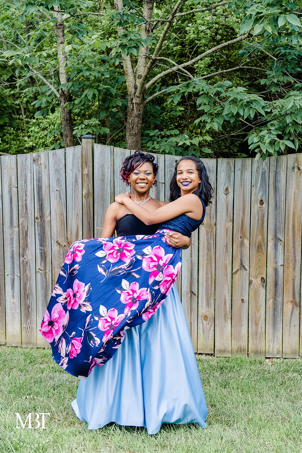 best friends prom session - one is carrying the other taken at a backyard in Fairfax, Virginia taken by a Northern Virginia portrait photographer