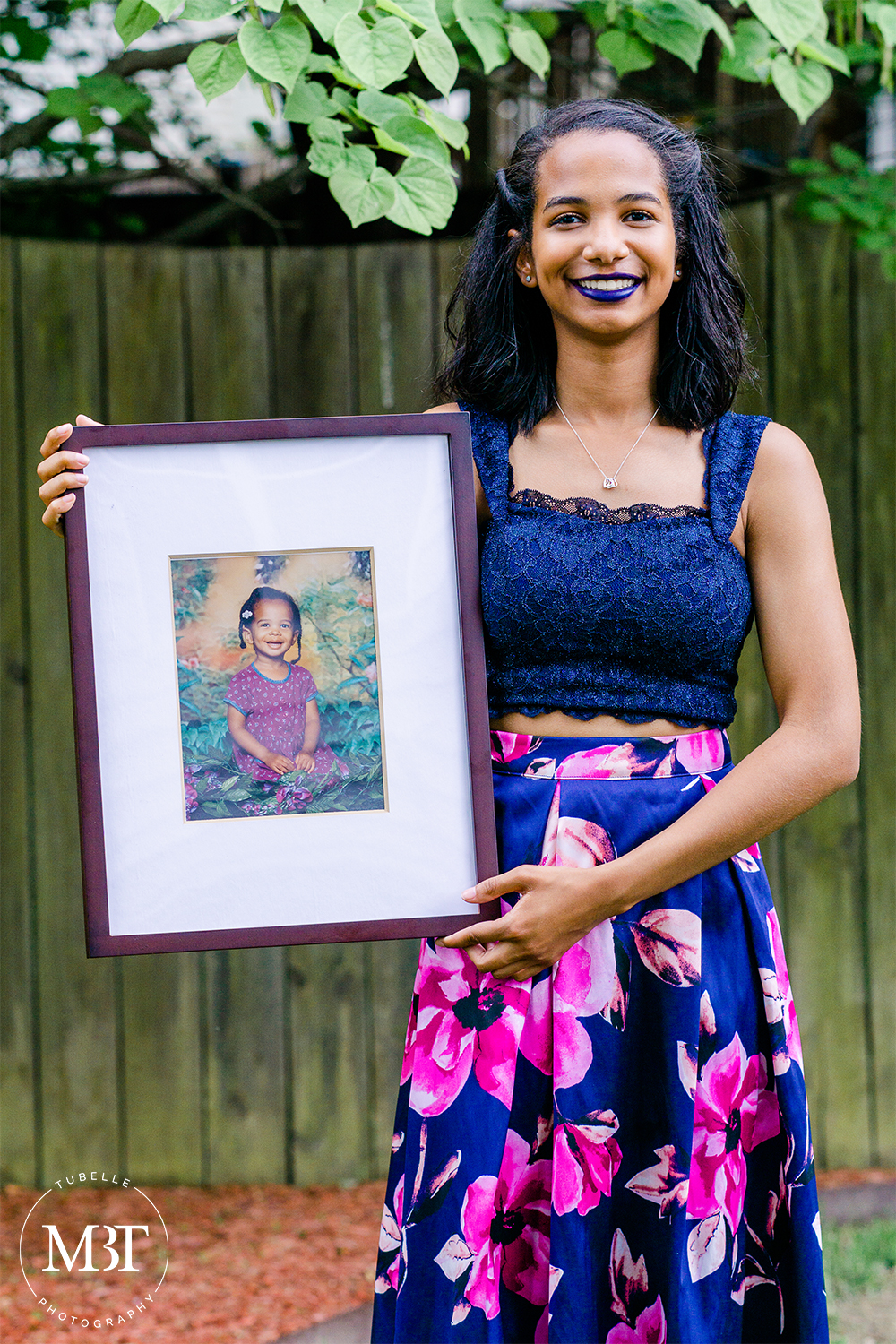 portrait of a teenage girl holding her baby picture, taken on her prom night at a backyard in Fairfax, Virginia by a Northern Virginia portrait photographer