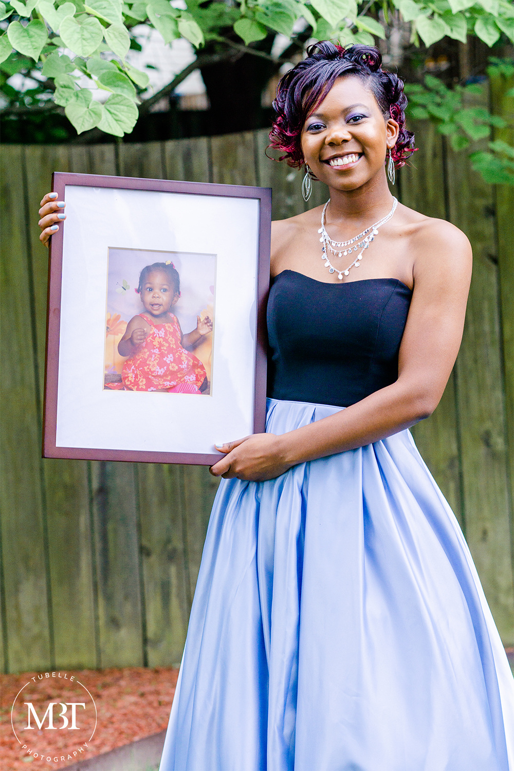 prom session - portrait of a teenage girl holding her baby picture, at a backyard in Fairfax, Virginia by a Northern Virginia portrait photographer