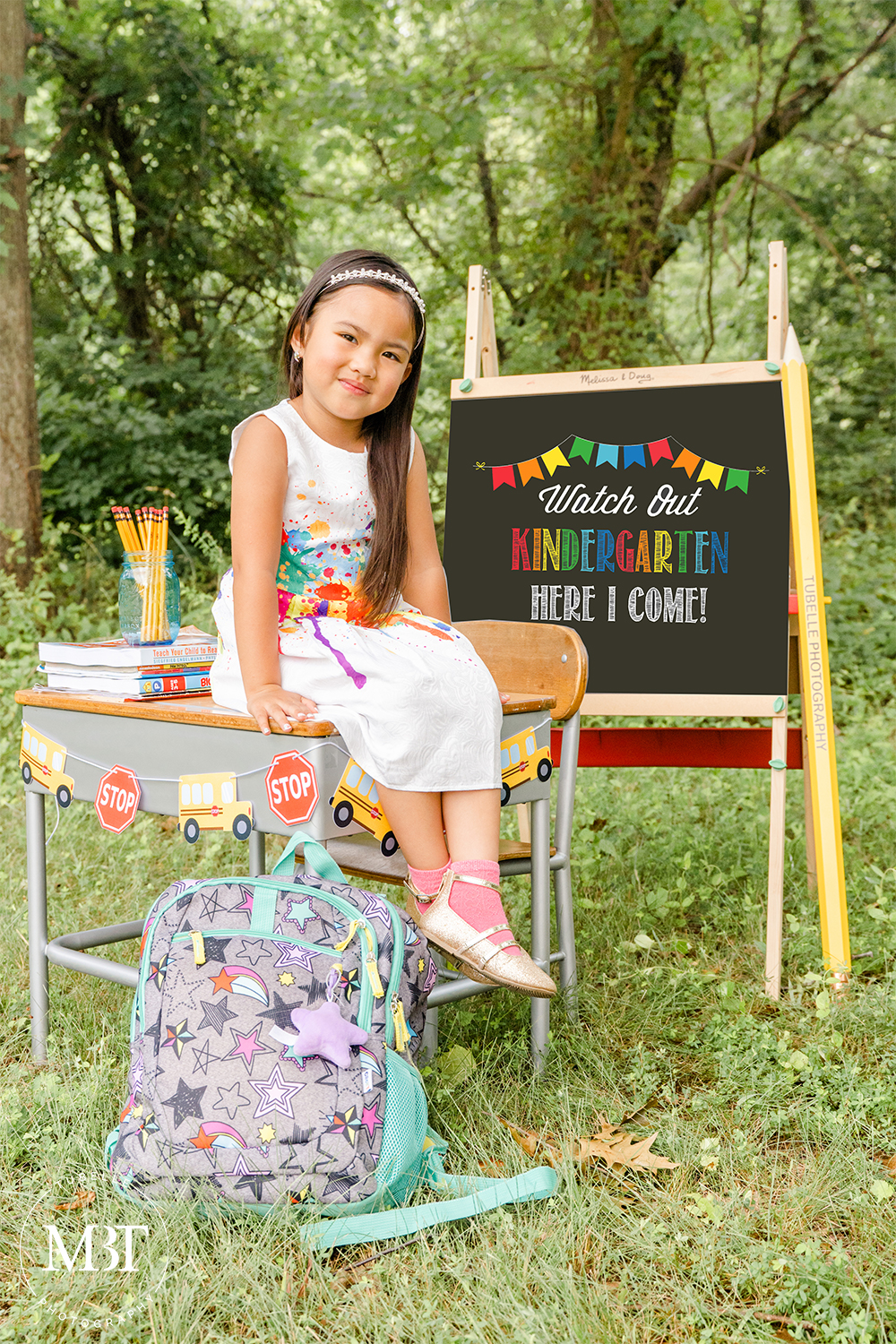 girl sitting on a table smiling at a back to school mini session done in Northern Virginia by portrait photographer in Northern Virginia