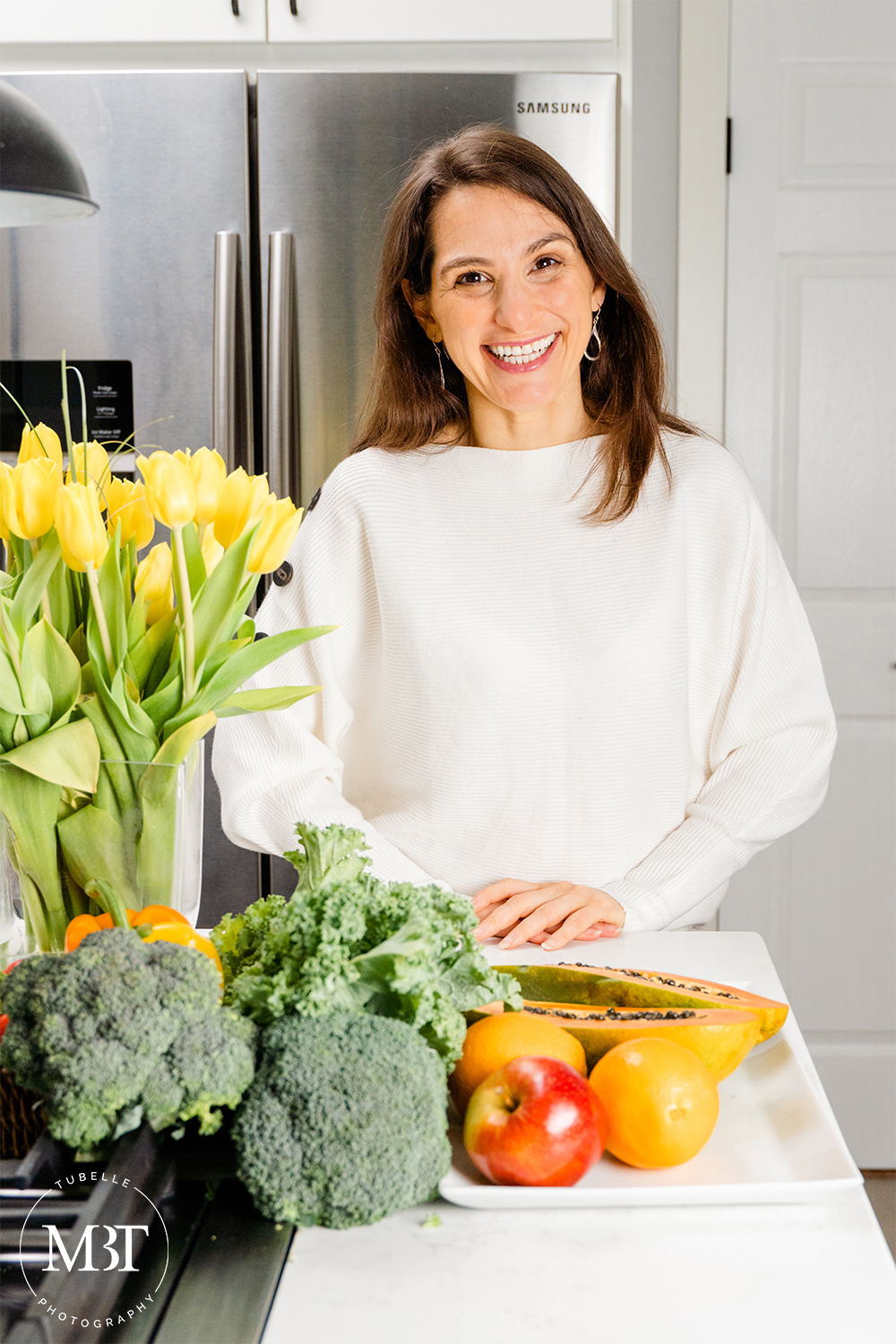 branding session - life coach in her kitchen surrounded by vegetables and fruits, taken in Northern Virginia by a lifestyle photographer in Washington, DC