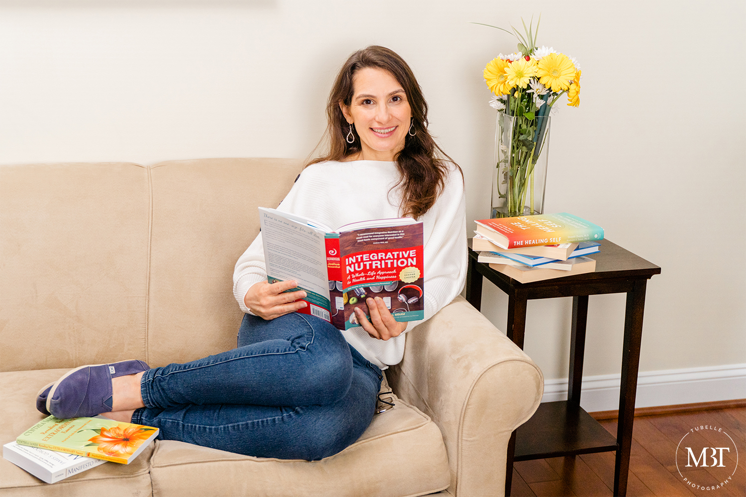 lifestyle session - life coach in her living room couch reading a nutrition book, taken in Northern Virginia by a branding photographer in DC