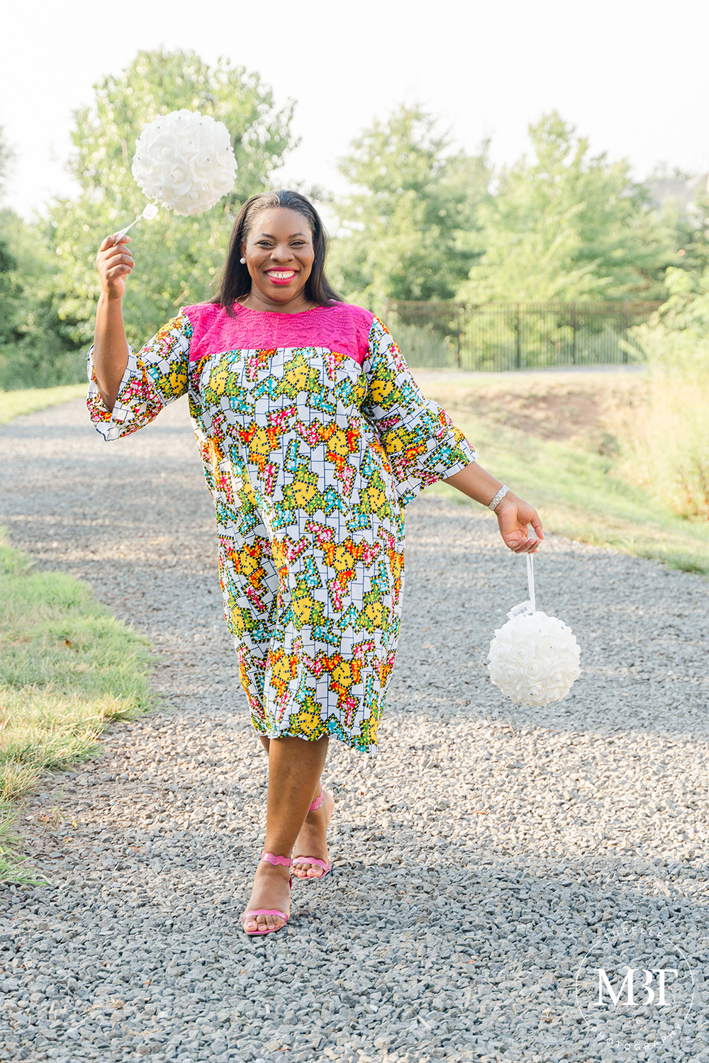 woman holding pom poms while walking taken in Loudoun County, by a portrait photographer in DMV