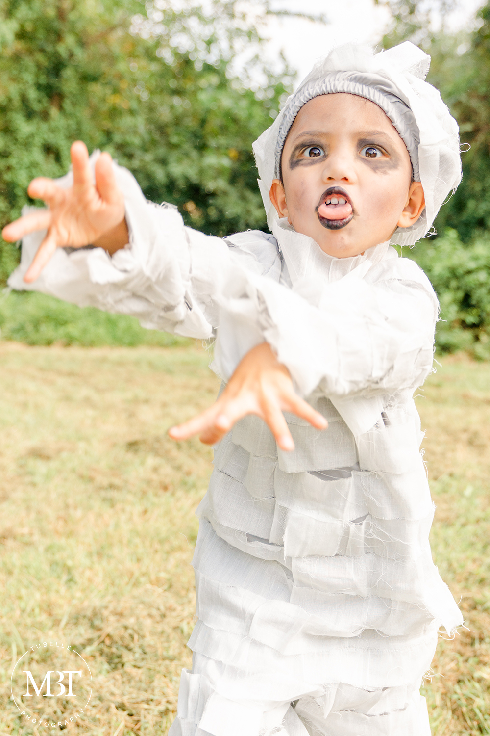 little boy wearing a mummy costume at a halloween themed session in Chantilly, Virginia taken by a Northern Virginia family photographer