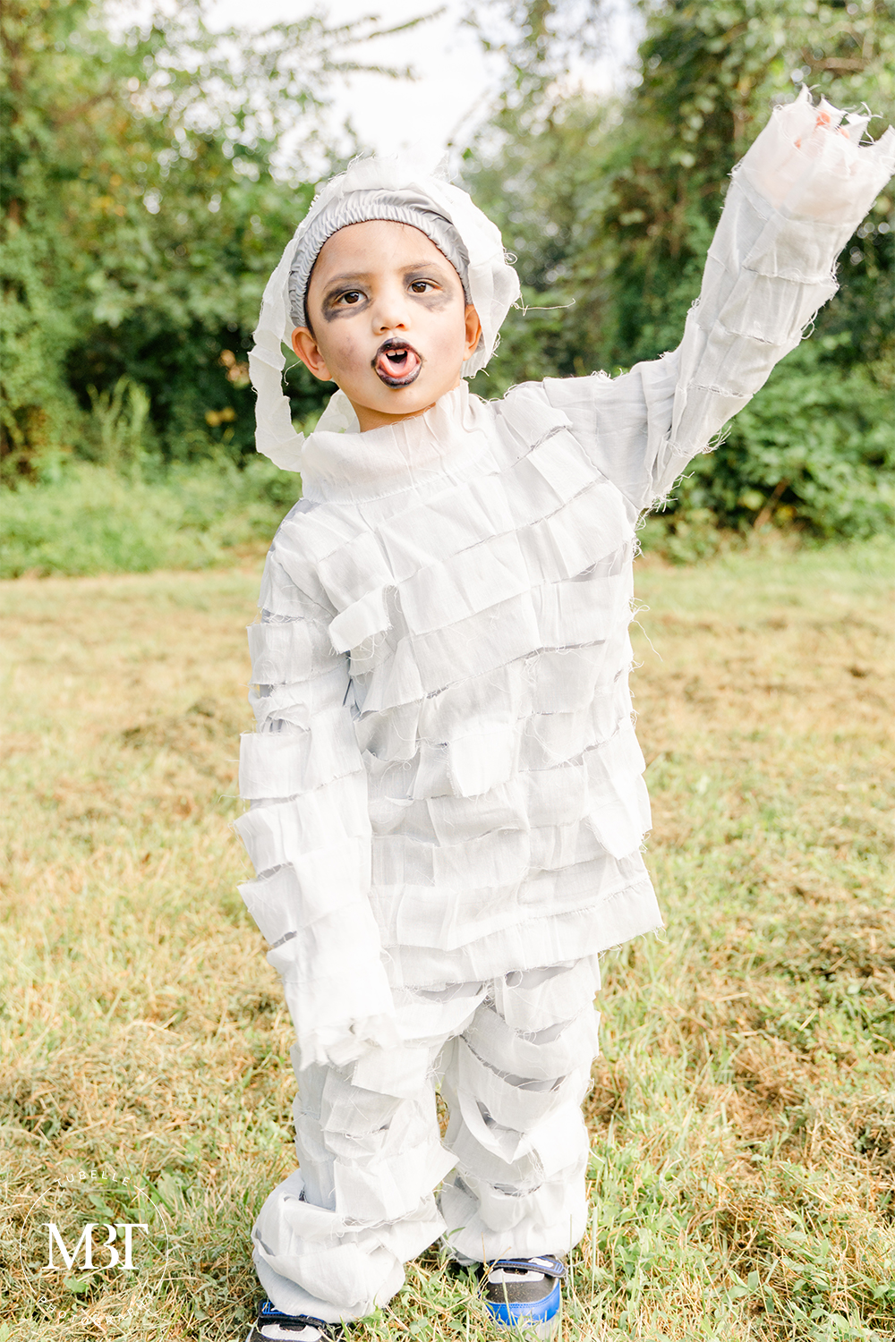 little boy wearing a mummy costume at a halloween themed session in Chantilly, Virginia taken by a Washington, DC family photographer