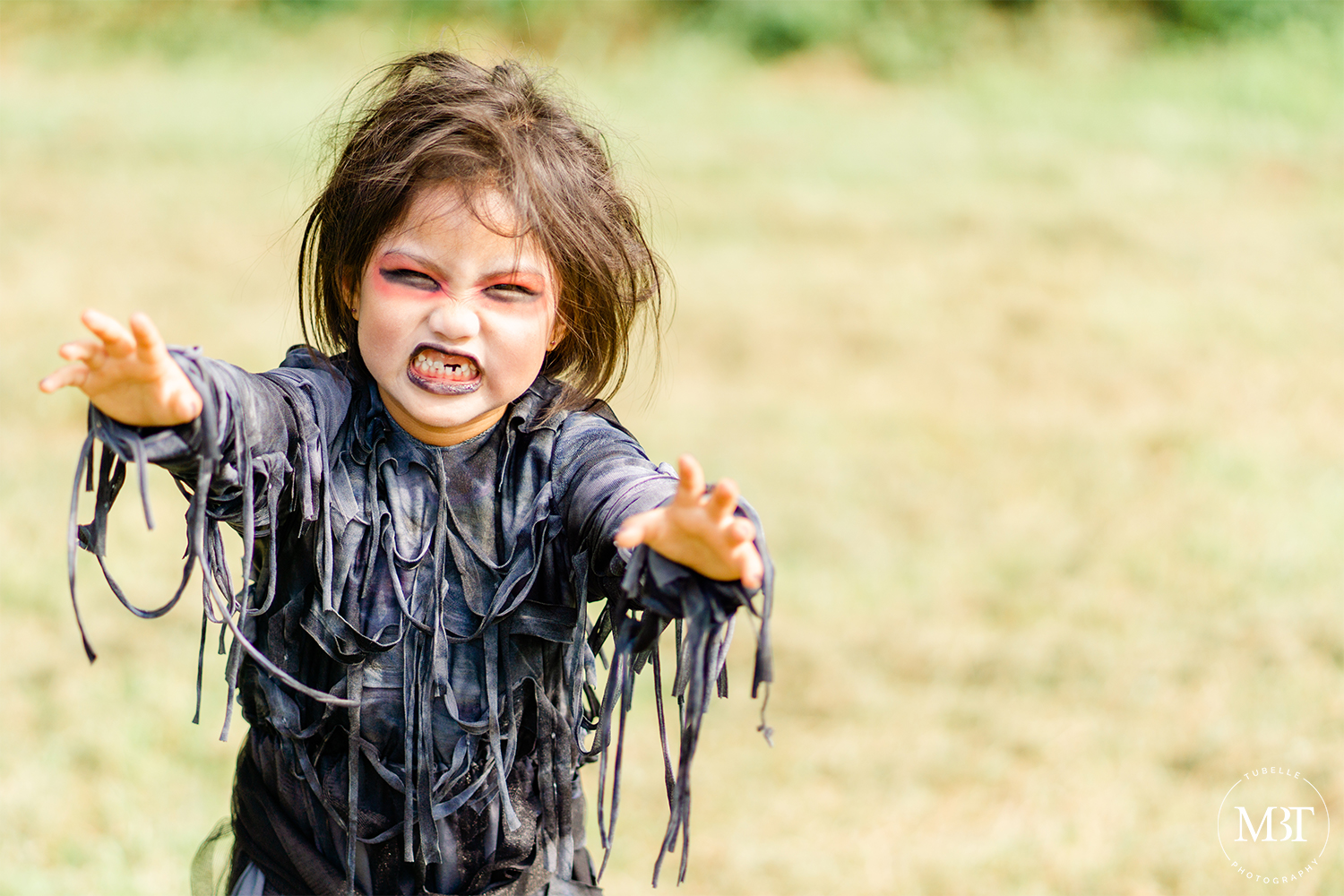 little girl wearing a zombie costume at a halloween themed session in Chantilly, Virginia taken by a DMV family photographer