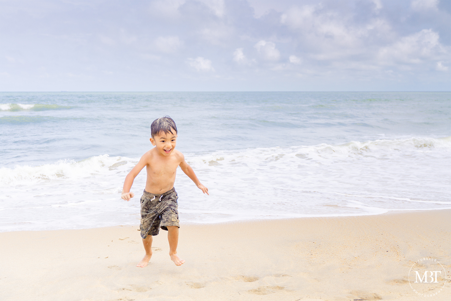 boy running from the beach, taken in Virginia Beach by a Washington, DC portrait photographer