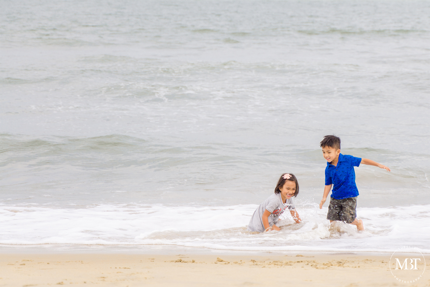 siblings playing at the beach, taken in Virginia Beach by a DMV portrait photographer