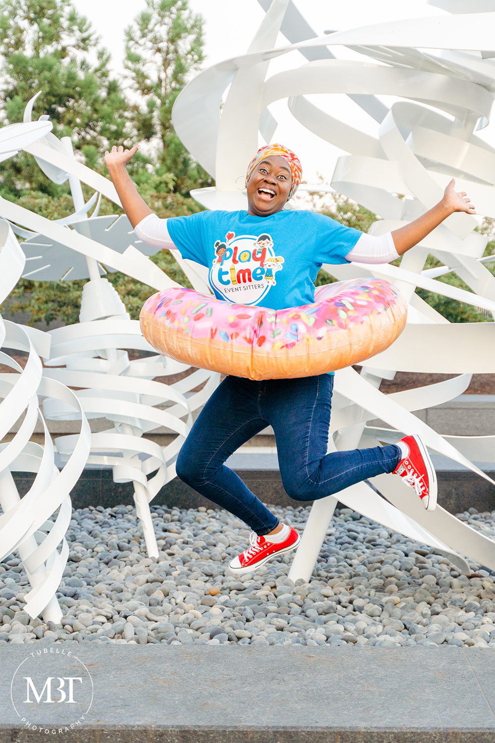 woman jumping with a donut floatie in her waist in a personal branding session, taken in Tysons, Virginia by a Northern Virginia photographer
