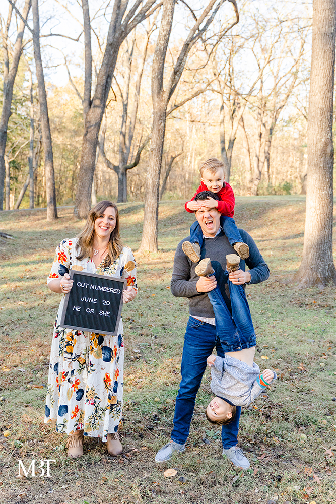 pregnancy announcement for a family of 4 during their maternity session in Chantilly, Virginia by a Virginia maternity photographer