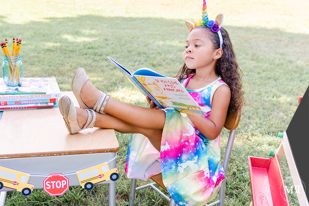 school aged girl reading during her back to school session at Cabel's Mill of EC Lawrence Park in Chantilly, Virginia by a Northern Virginia children's photographer