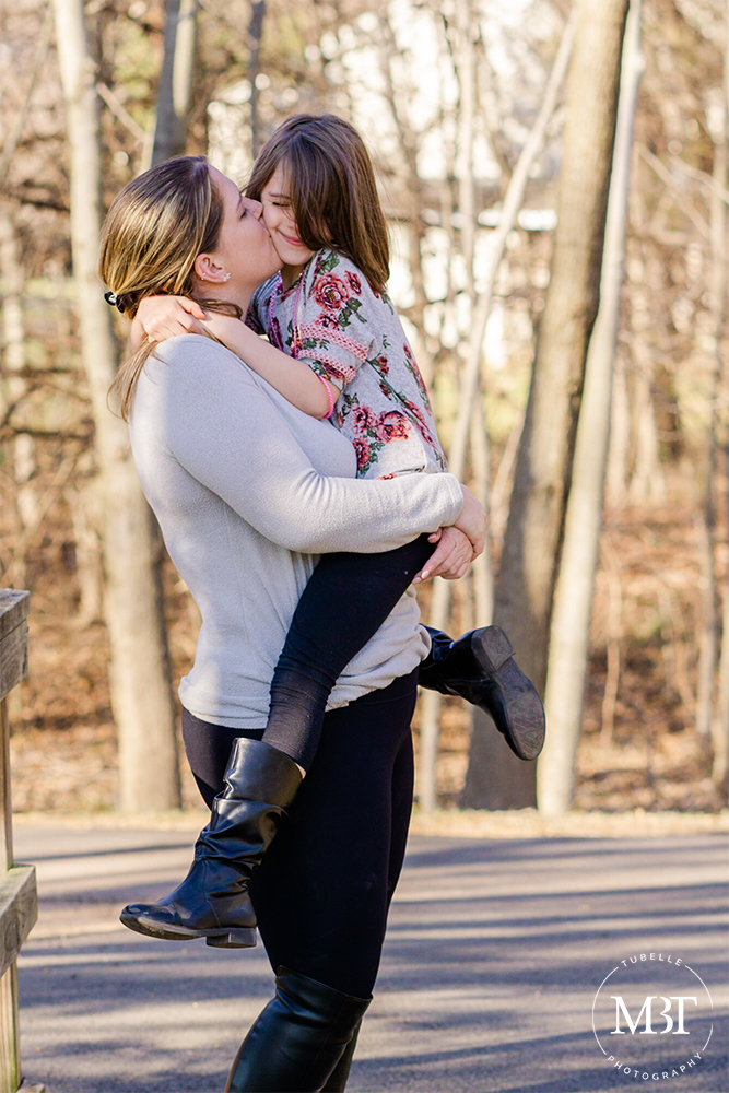 mommy kissing daughter during their family session in Herndon, Virginia by a Virginia family session