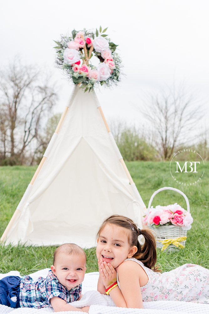 siblings laughing during their spring session at Ida Lee Park in Leesburg, Virginia by a Washington, DC family photographer