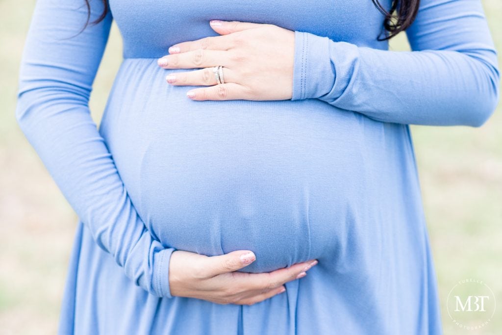 close up shot of pregnant belly during a maternity session in Gainesville, Virginia taken by a Virginia maternity photographer
