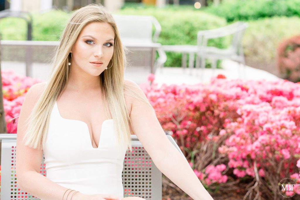 girl wearing a white dress during her senior session in Reston, Virginia by a Fairfax County Virginia photographer