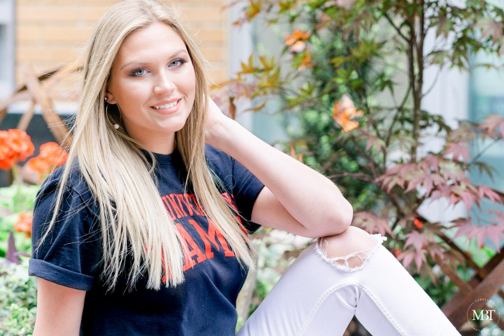 girl wearing a University of Tampa tee during her senior session in Reston, Virginia taken by a Gainesville, Virginia senior photographer