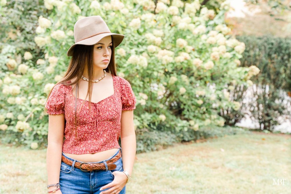 girl wearing hat during a senior session at Airlie taken by a prince william county senior photographer