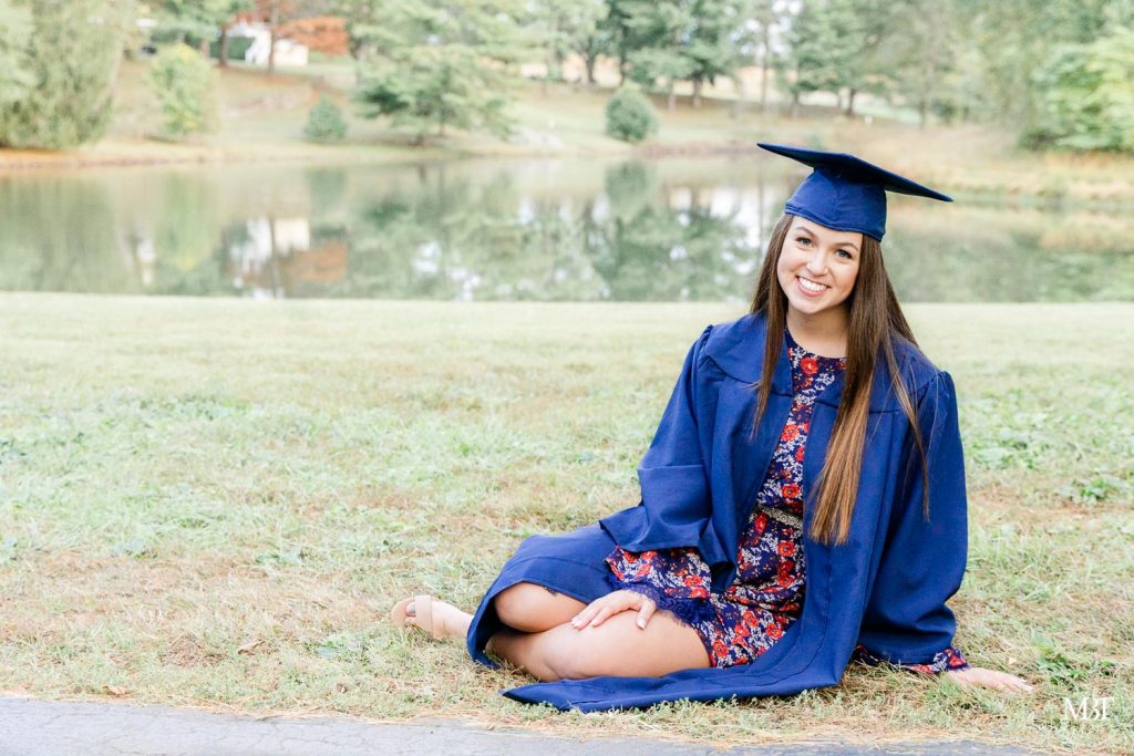 girl wearing graduation gown during a senior session in Warrenton, Virginia taken by a Virginia photographer