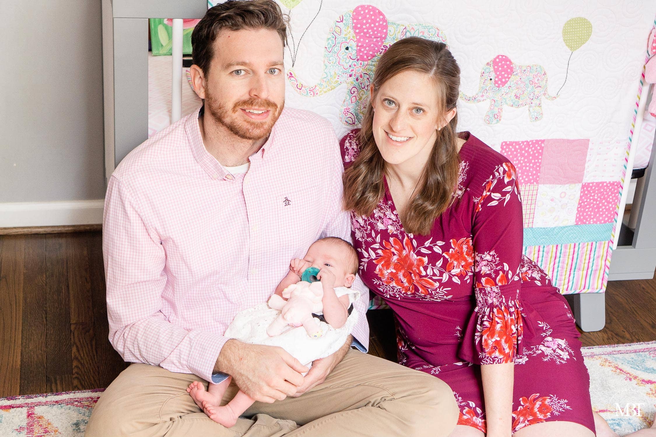 baby girl with her parents during newborn pictures in Arlington, Virginia taken by TuBelle Photography, a newborn photographer in Northern Virginia