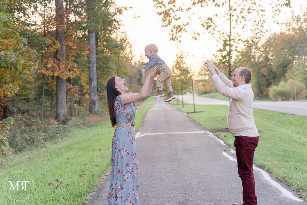 mom & dad playing with son during their family photos at Willowsford in Aldie, Virginia taken by TuBelle Photography, a Virginia family photographer