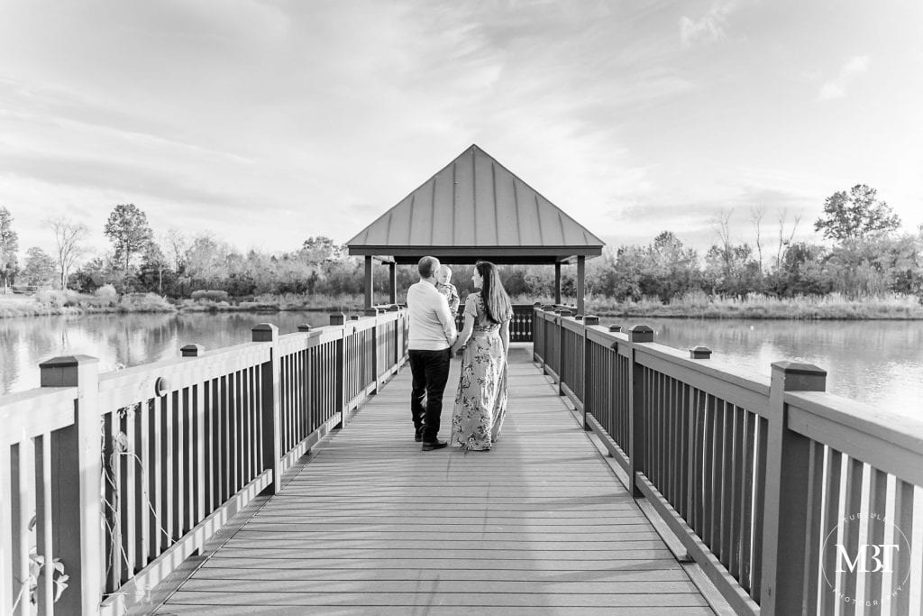 family of 3 walking at the boat pier during their family photos in Aldie, Virginia, taken by TuBelle Photography, a Virginia family photographer