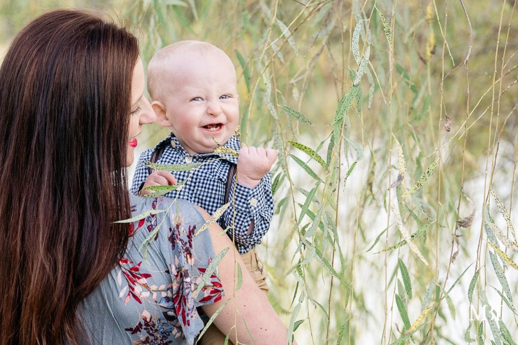 mom and son playing with leaf during their family pictures at Willowsford in Aldie, Virginia taken by TuBelle Photography, a Virginia family photographer