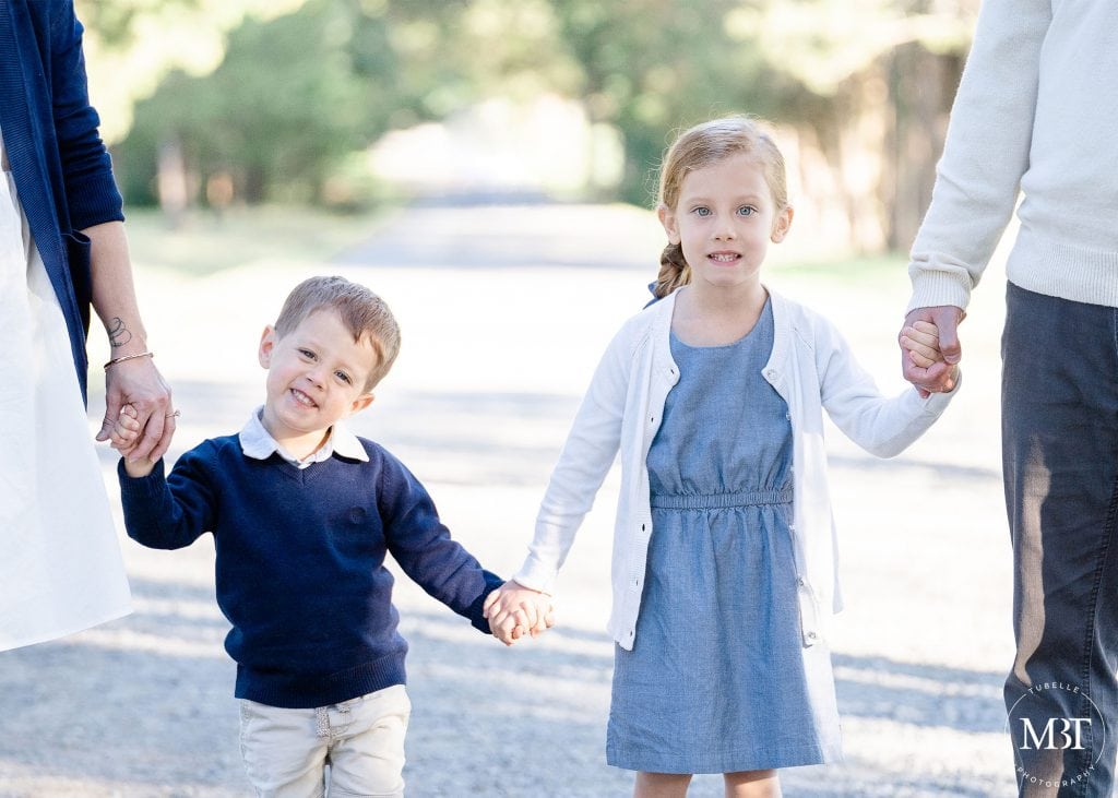 siblings holding mom & dad's hands during their family session in Sterling, Virginia, taken by TuBelle Photography, a Northern Virginia family photographer