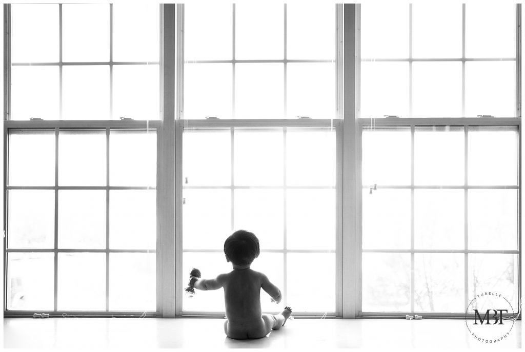 baby boy sitting by the window taken in McLean, Virginia by TuBelle Photography, a Northern Virginia milestone photographer