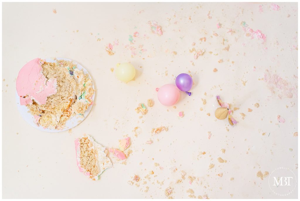 cake with tons of crumbs during unicorn themed cake smash photos in Gainesville, Virginia taken by TuBelle Photography, a NoVa cake smash photographer