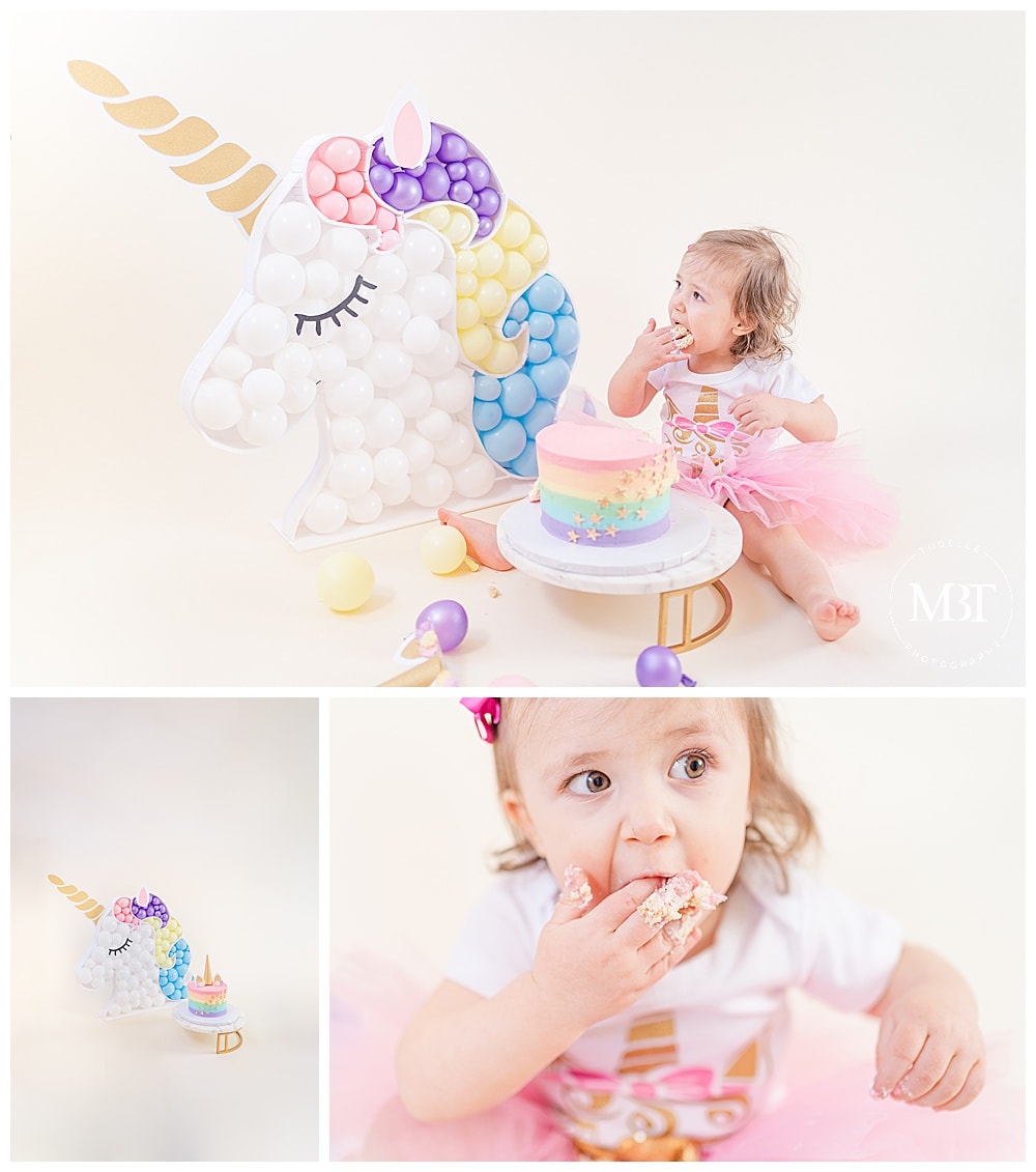 girl eating her unicorn themed cake during cake smash pictures in Gainesville, Virginia by TuBelle Photography, a DMV cake smash photographer