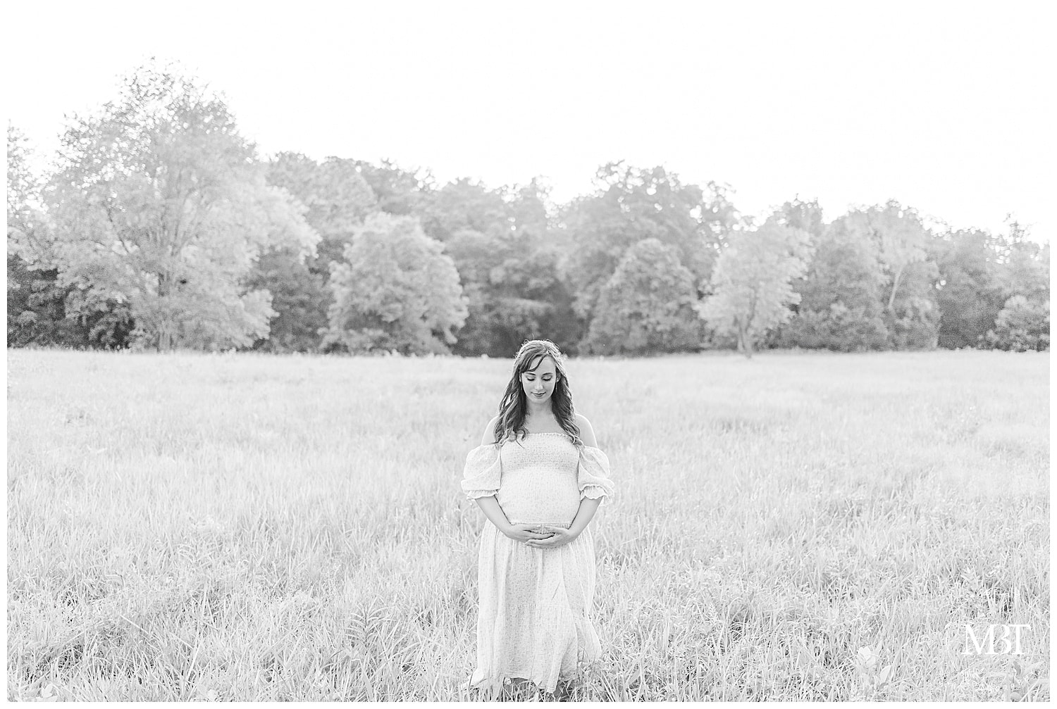 first time expecting mom looking at her belly during her maternity portraits at Manassas Battlefield, taken by TuBelle Photography, a Northern Virginia maternity photographer