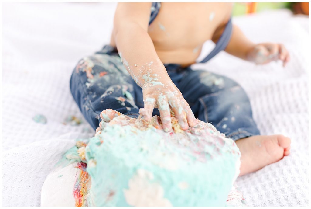 baby's hand on cake during time flies cake smash in Northern Virginia