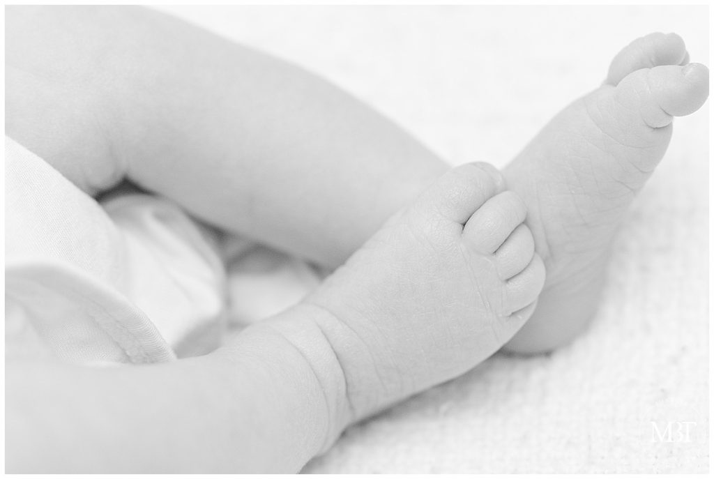 baby's feet during her newborn pictures, taken in Arlington, Virginia by a DMV lifestyle newborn photographer