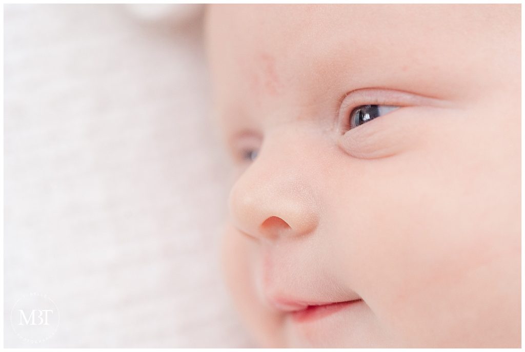close up of baby's face during her newborn session, taken in Arlington, Virginia by a DMV lifestyle newborn photographer