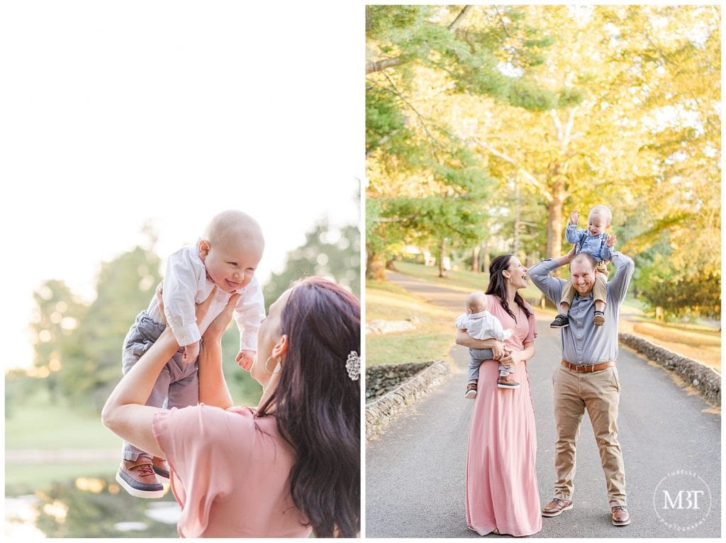 Son on dad's shoulders as mom and baby look up and smile at him at their fall family session at Airlie in Warrenton, Virginia taken by TuBelle Photography, a Prince William County Family Photographer.