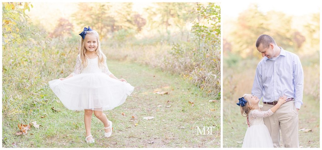 Little girl curtsies in white dress and looks up and smiles at Daddy while hugging him for their fall mini session in Chantilly, Virginia. Taken by TuBelle Photography, a Northern Virginia Photographer.