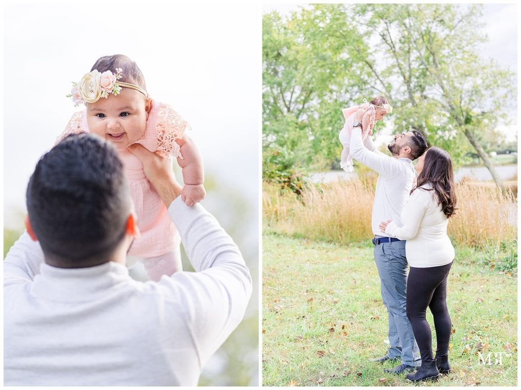 Dad lifts baby girl in the air at their Christmas Mini Session taken by TuBelle Photography, a Northern VA Family Photographer.