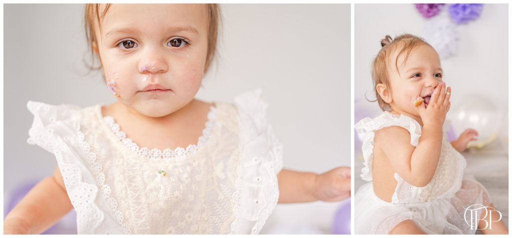 Little girl with cake icing on her face. Little girl grabbing a piece of cake for cake smash photos. Taken by TuBelle Photography, a NoVa cake smash photographer.