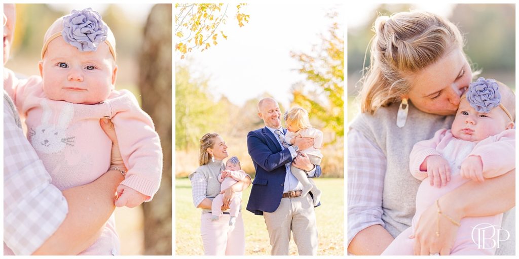 Mom and Dad holding daughters and kissing baby's cheek for fall mini session in Sterling, Virginia. Taken by TuBelle Photography, a Northern Virginia Photographer.