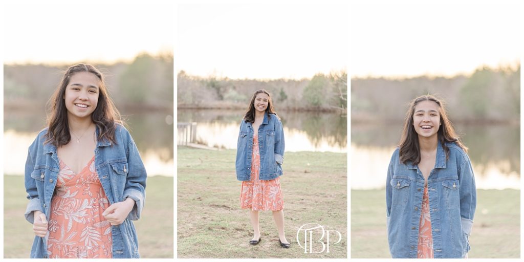 Senior girl in pink dress and denim jacket posing by a pond for her Claude Moore Park senior session taken by TuBelle Photography, a Sterling, Virginia Senior Photographer.