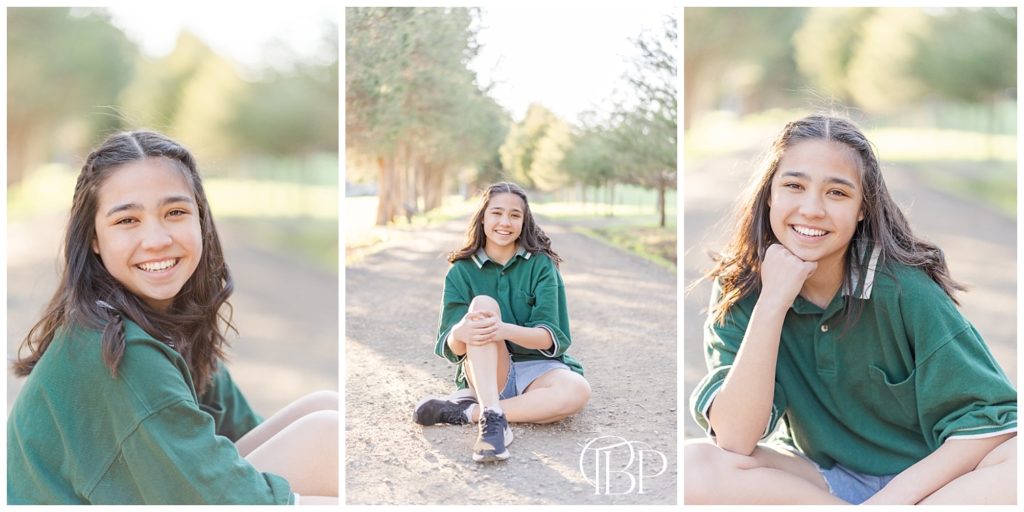 Senior girl in green shirt sitting on a road for her Claude Moore Park senior pictures taken by TuBelle Photography, a Sterling, Virginia Senior Photographer.