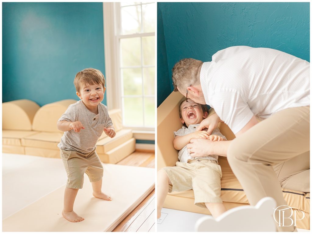Big brother dancing and getting tickled by dad for their living room newborn photos. Taken by TuBelle Photography, a Fairfax County, Virginia Newborn Photographer.