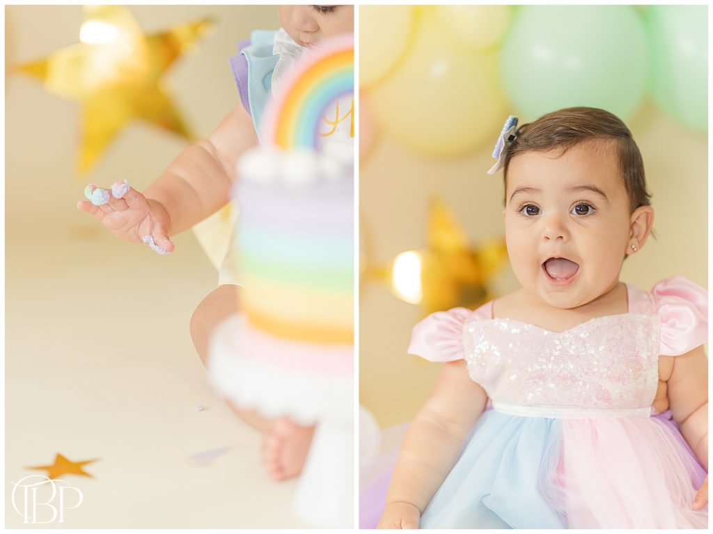 Baby girl's hand covered in icing for a rainbow themed cake smash session in Fairfax County, Virginia. Taken by TuBelle Photography, a Fairfax County, VA Cake Smash Photographer.