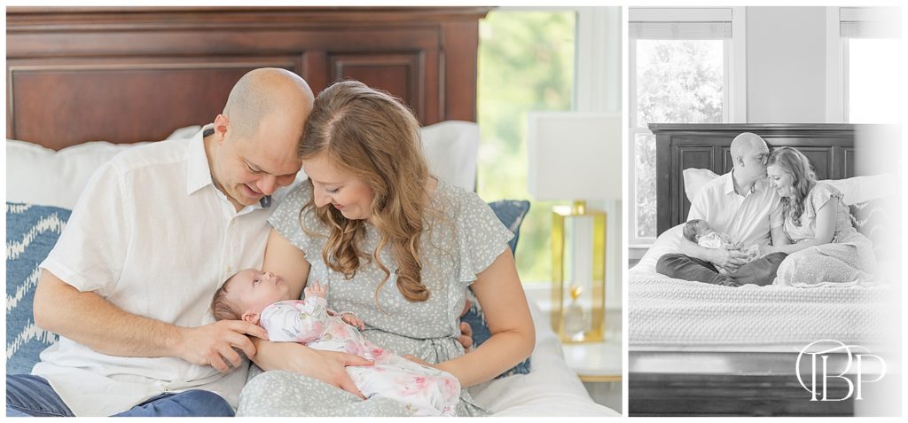 Mom and Dad holding baby girl on the bed in their master bedroom for lifestyle newborn photos in Centerville, Virginia taken by TuBelle Photography.