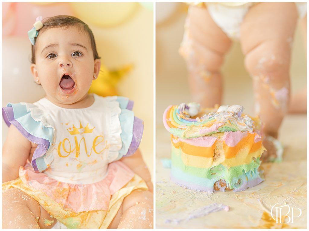 Baby girl standing in her rainbow cake for her cake smash photos in Fairfax County, VA. Taken by TuBelle Photography, a cake smash photographer.