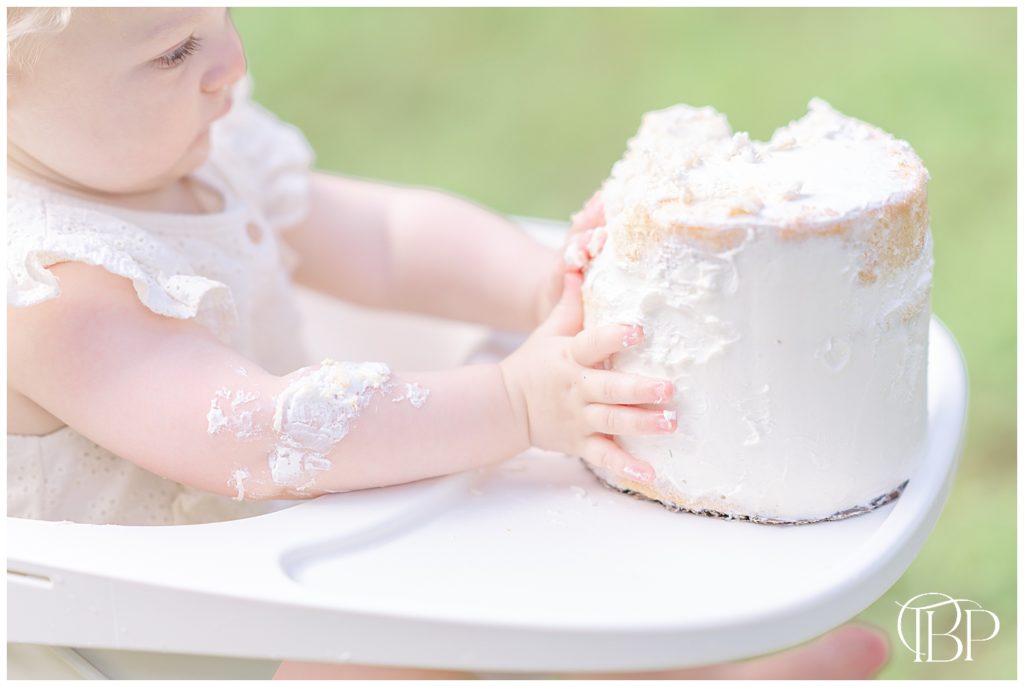 baby playing with cake on her high chair in Warrenton, VA