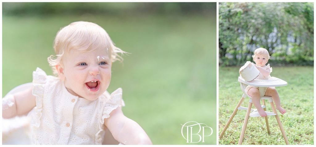 baby girl smiling and pushing cake out of her high chair during cake smash pictures at their Virginia backyard
