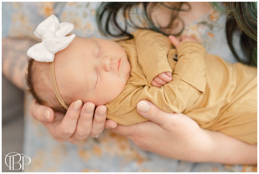 Mom holding baby taken by a Haymarket, VA lifestyle newborn photographer