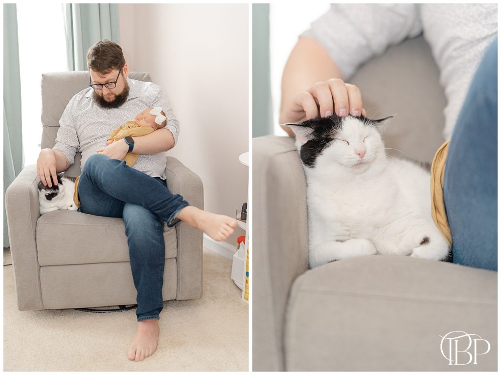 Dad holding baby girl while petting cat on the rocker taken by a lifestyle newborn photographer in Haymarket, VA